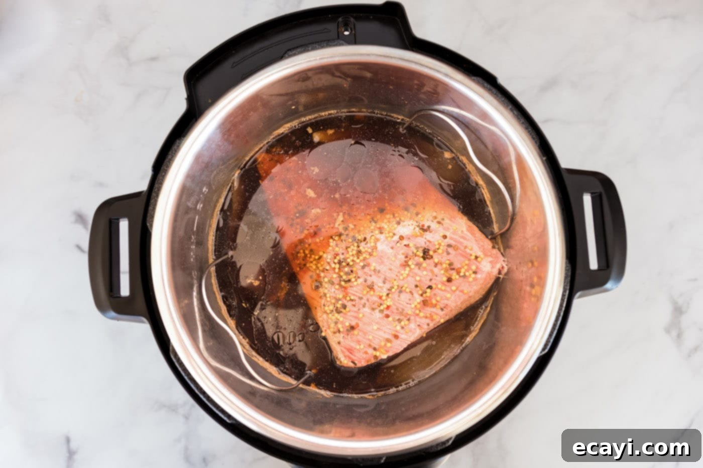 Tender Instant Pot Corned Beef 8 Cooked corned beef brisket resting in the Instant Pot after pressure cooking.