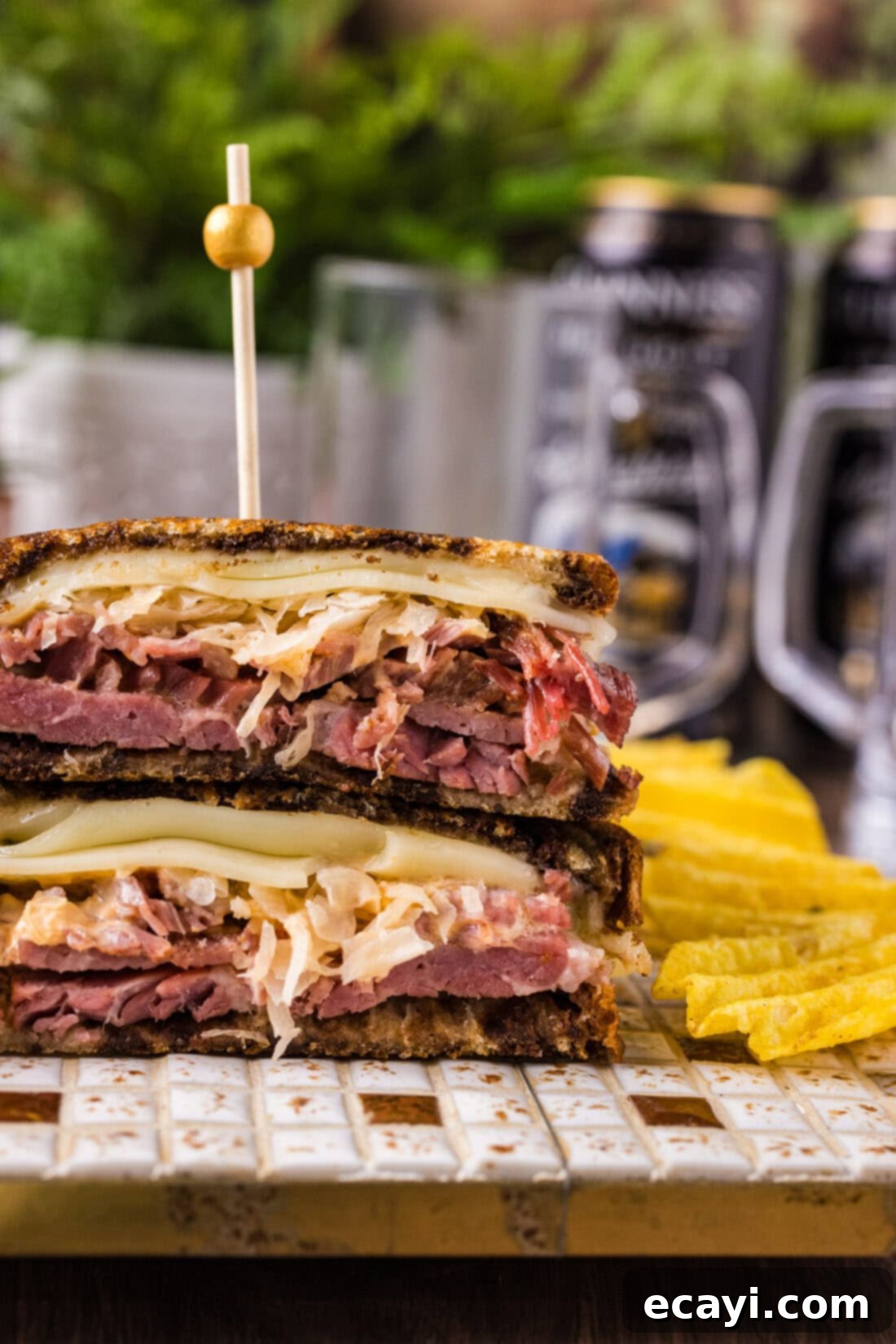 Classic Reuben Sandwich 3 Close-up photo of a perfectly assembled, cut-in-half Reuben Sandwich, showcasing its layers of corned beef, sauerkraut, Swiss cheese, and dressing on rye bread.