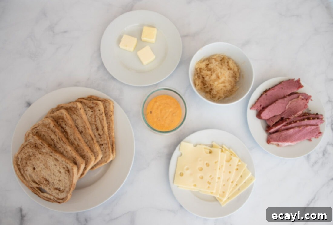 Classic Reuben Sandwich 4 A vibrant display of all the fresh ingredients needed to prepare a classic Reuben Sandwich, including rye bread, corned beef, Swiss cheese, sauerkraut, and Thousand Island dressing.