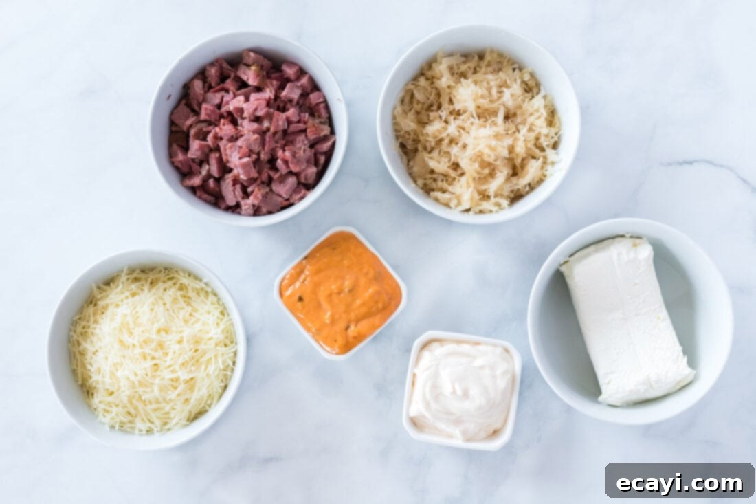 Decadent Reuben Dip 4 Ingredients laid out for Reuben Dip recipe including corned beef, Swiss cheese, sauerkraut, cream cheese, mayonnaise, and Thousand Island dressing