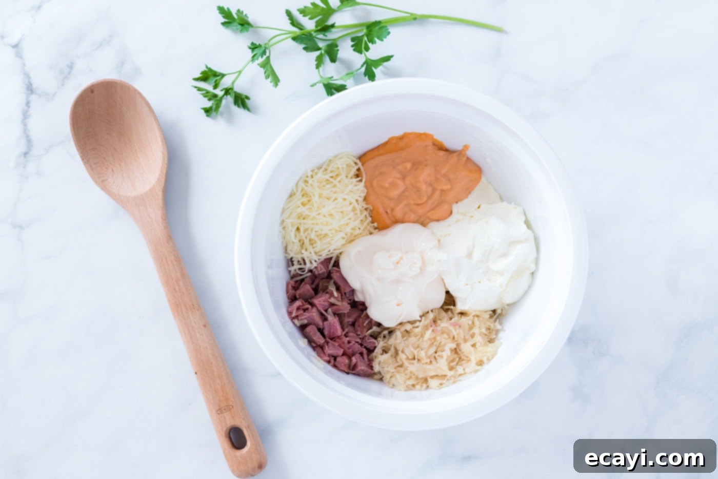 Decadent Reuben Dip 5 reuben dip ingredients mixed in a bowl