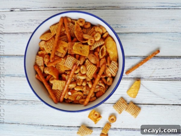 Taco Chex Mix An overhead photo of a bowl of taco chex mix, showcasing the savory blend of cereals, chips, and pretzels.