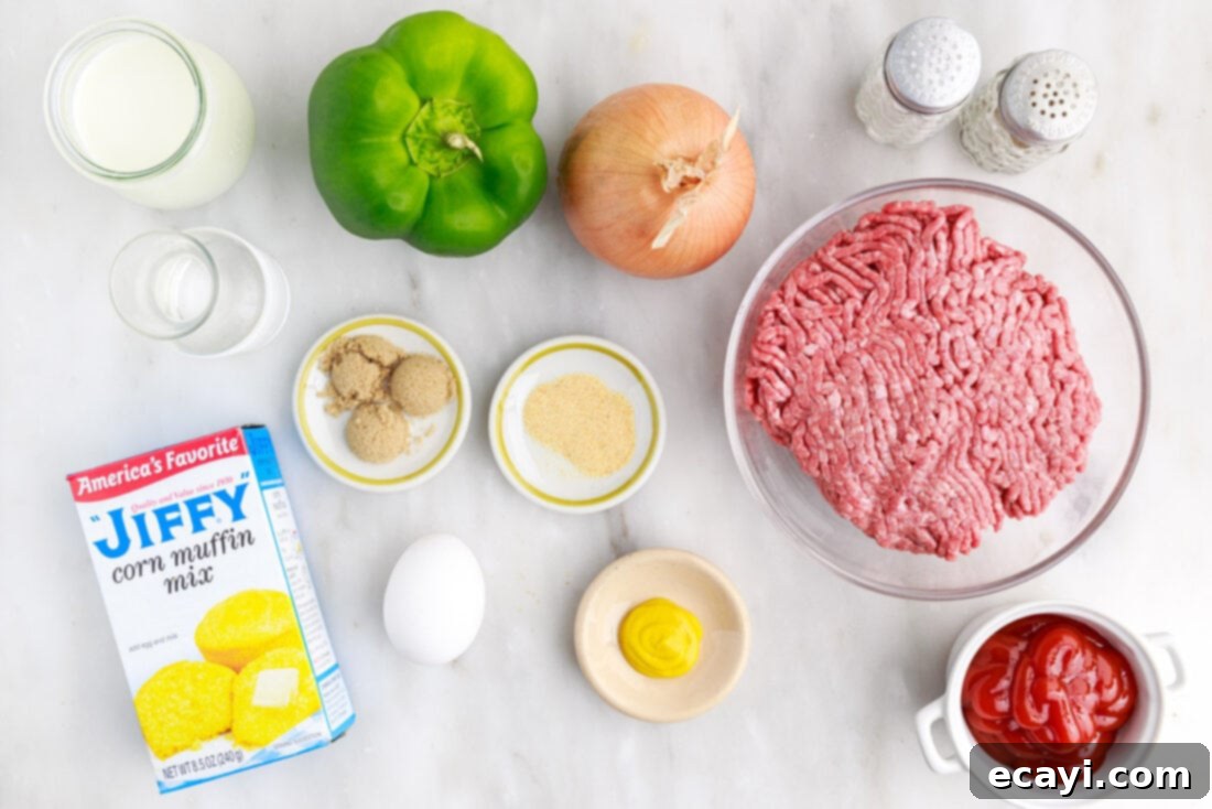 Hearty Sloppy Joe Cornbread Bake 4 All ingredients laid out for Sloppy Joe Cornbread Casserole: ground beef, onion, bell pepper, seasonings, ketchup, mustard, brown sugar, cornbread mix, egg, milk
