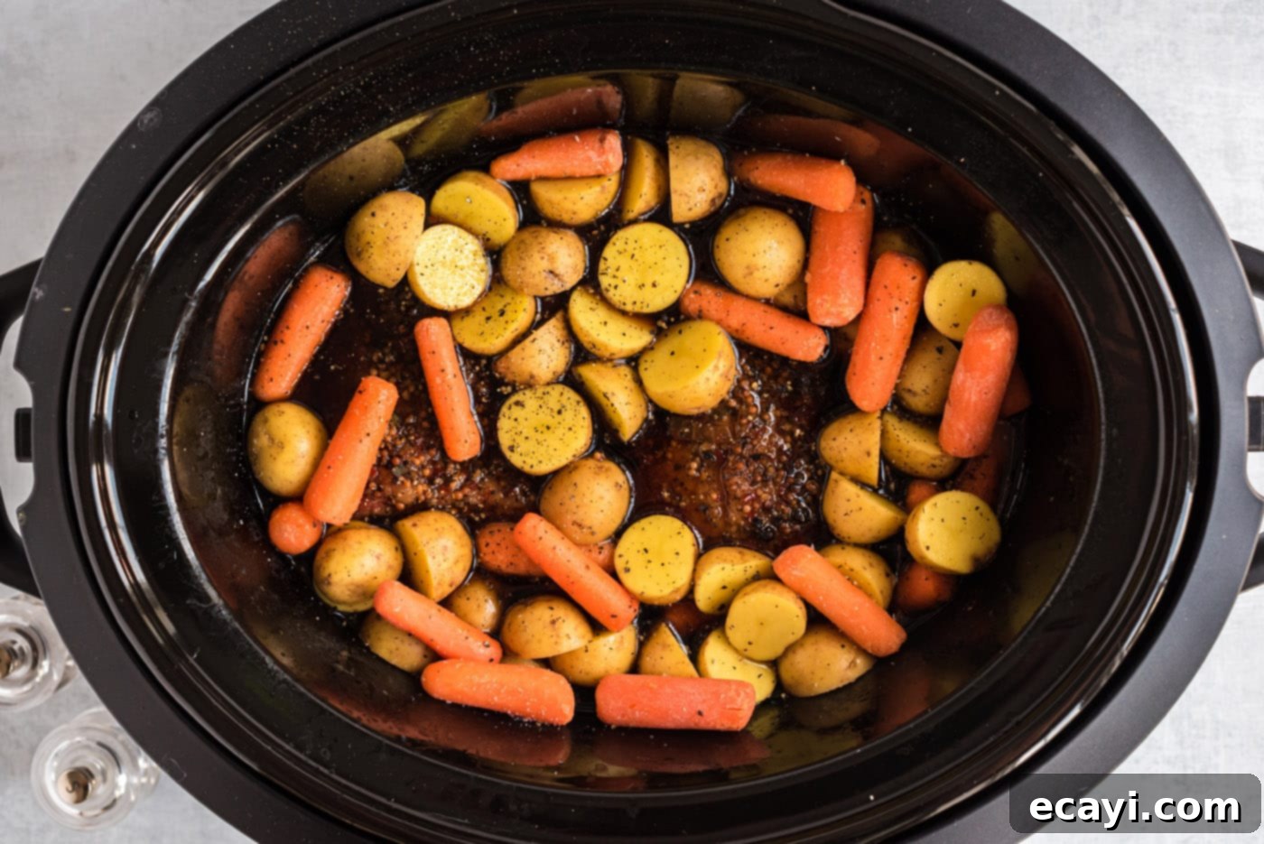 Slow-Cooked Tender Corned Beef 8 baby carrots and potatoes in a crockpot with corned beef