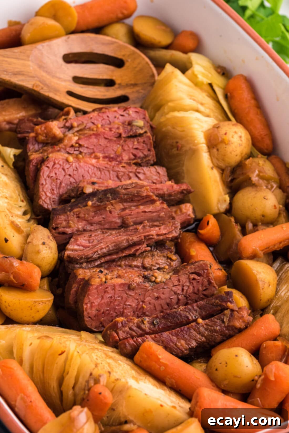Slow-Cooked Tender Corned Beef 10 Crockpot Corned Beef with a wooden spoon