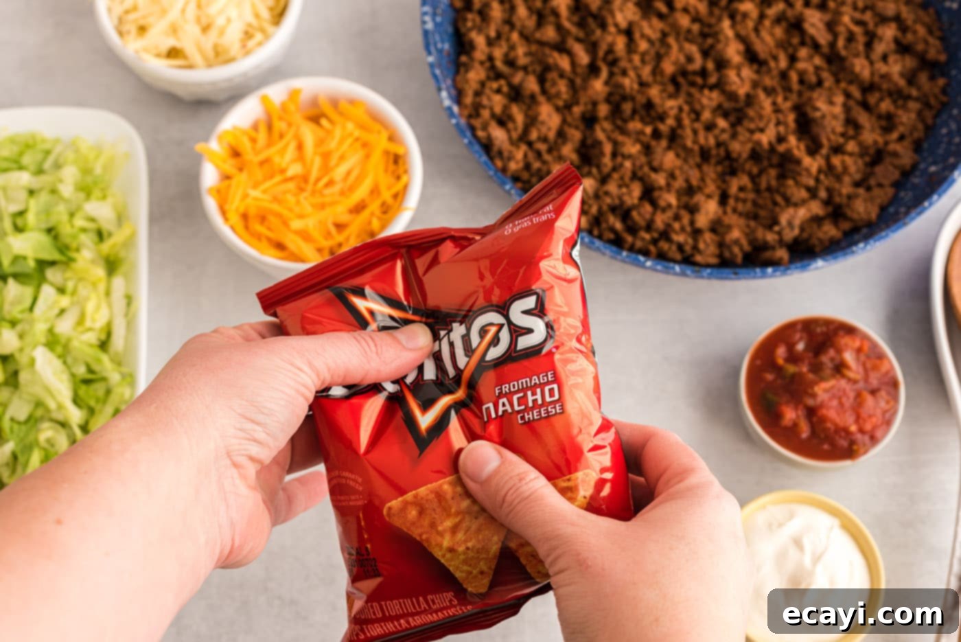 Portable Taco Crunch 6 Hand crushing a bag of chips