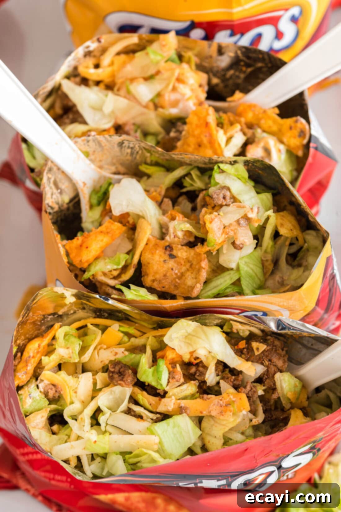 Portable Taco Crunch 10 Close-up view inside two Walking Taco bags, showing the mixture of chips, meat, and toppings