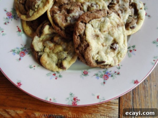 Double Stack Chocolate Chip Cookies A close up photo of a plate of half and half chocolate chip cookies, highlighting the beautiful contrast of chocolate and classic dough.