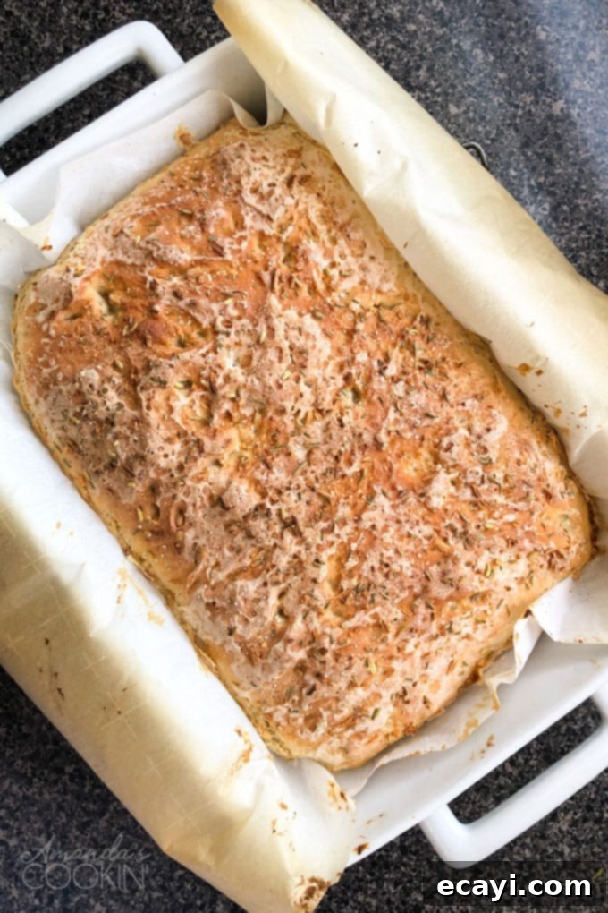The Everyday Hearth Bread 2 pachment paper lined baking pan with peasant bread from the oven