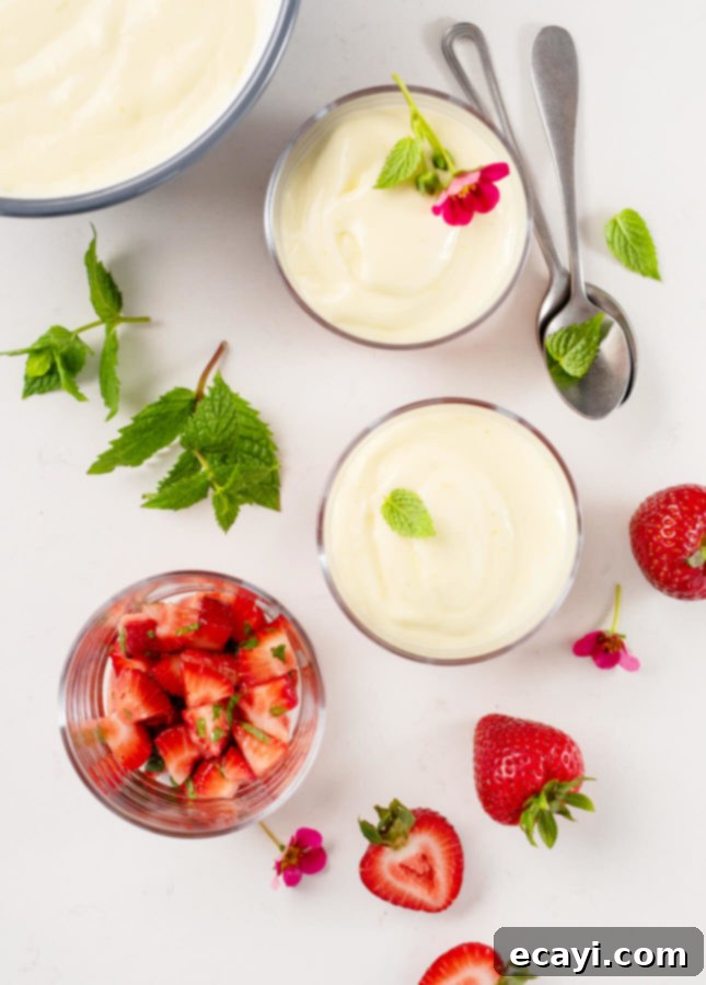 Refreshing Citrus Mousse with Macerated Strawberries 4 Elegant glass verrines filled with Citrus Mousse and Macerated Strawberries, ready to serve at a gathering