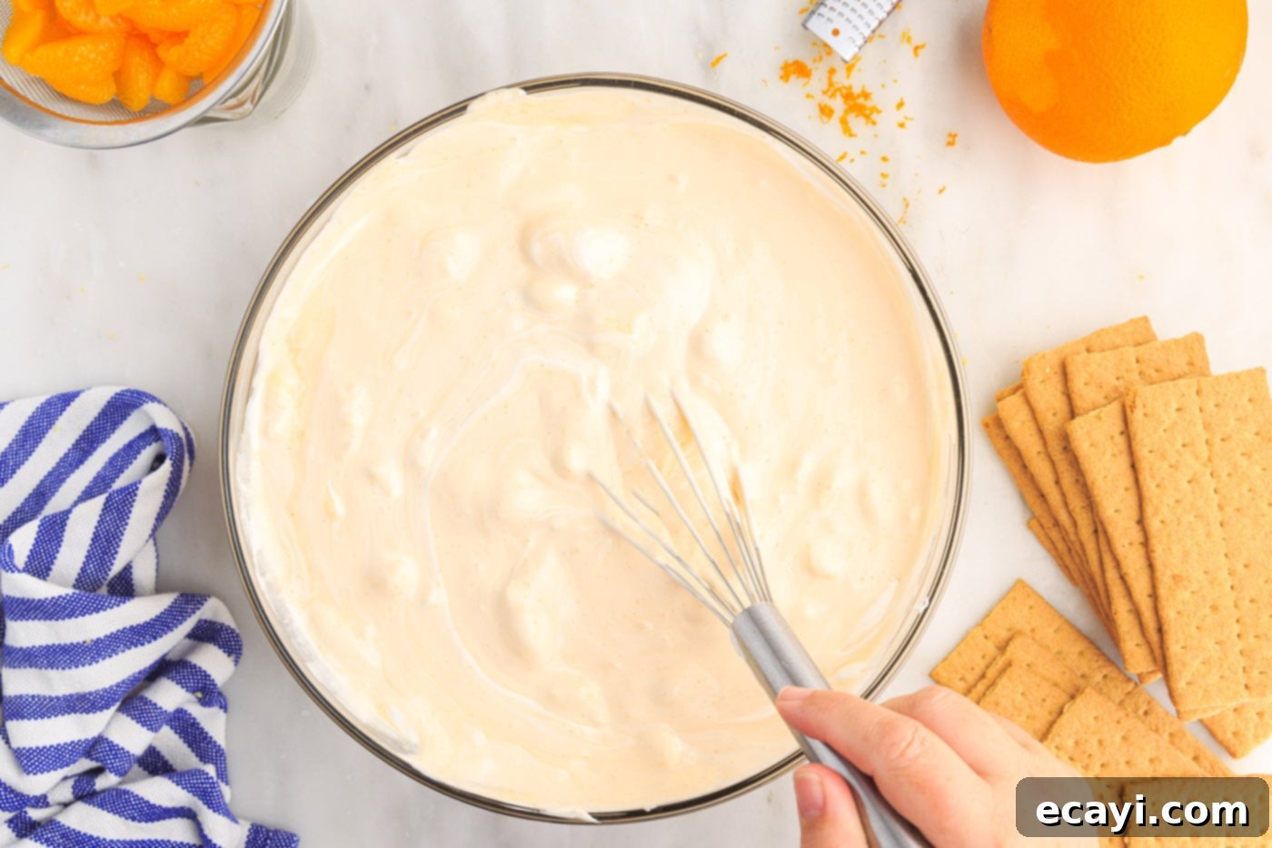Orange Dreamsicle Delight 11 whisking orange icebox cake mixture in a bowl