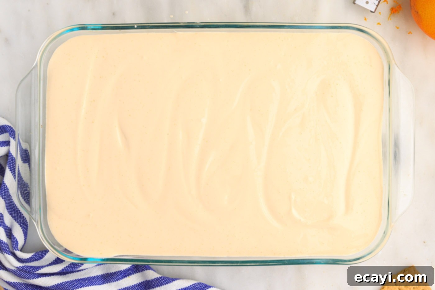 Orange Dreamsicle Delight 15 orange pudding mixture over graham crackers in a casserole dish