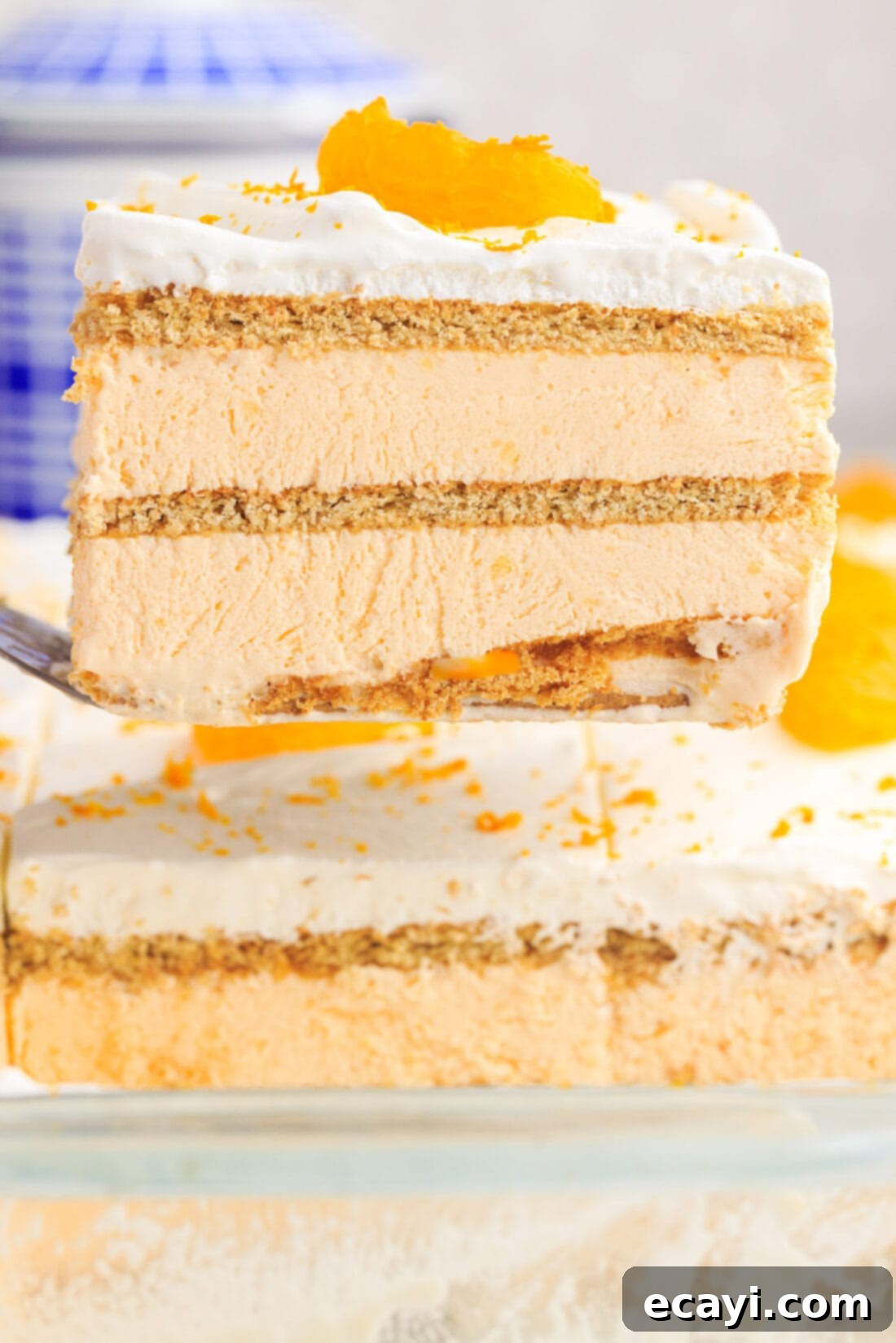 Orange Dreamsicle Delight 20 lifting a slice of Orange Icebox Cake with spatula