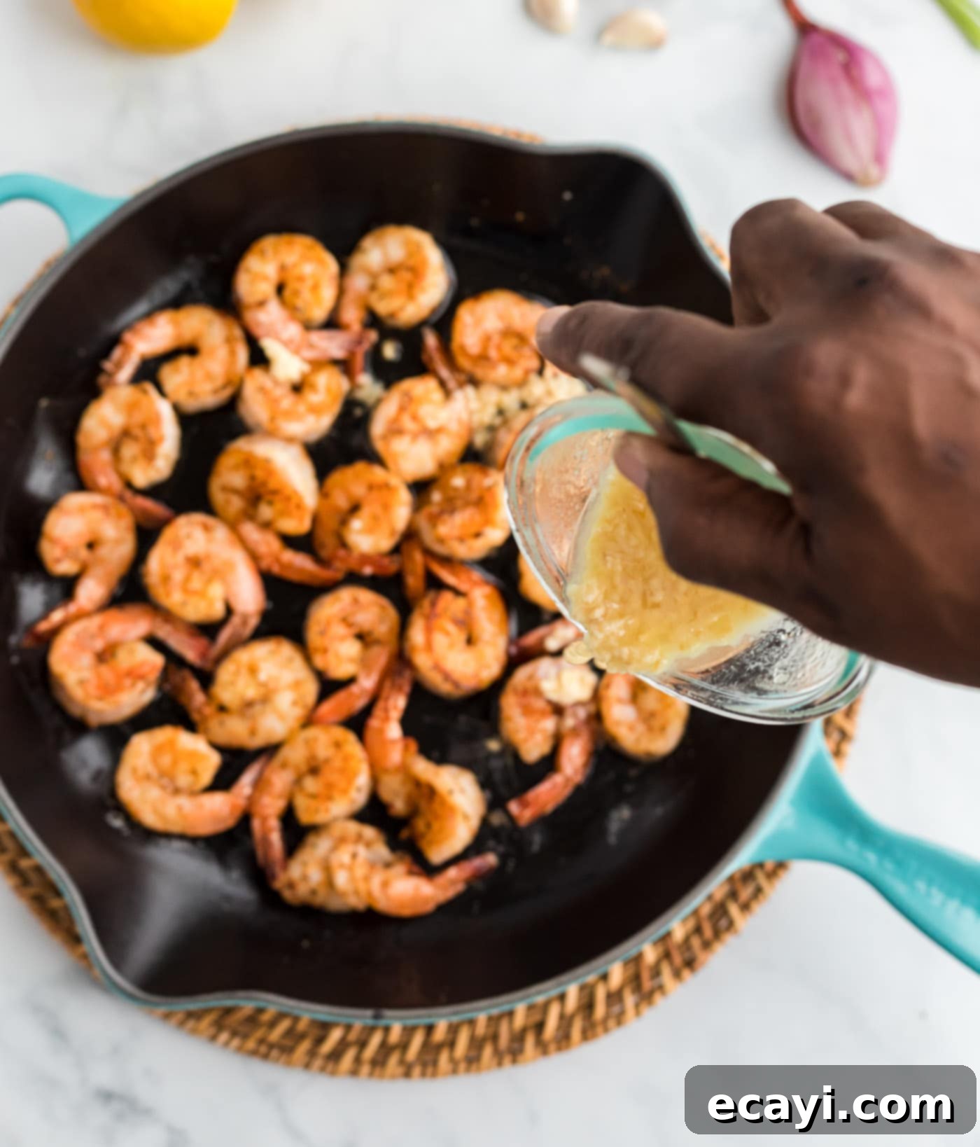 Shrimp Sauté 9 pouring butter sauce into skillet of sauteed shrimp
