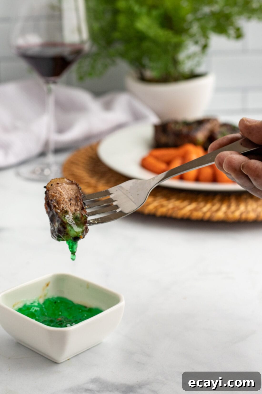 Succulent Herb-Crusted Lamb Chops 11 Fork dipping a lamb chop into mint jelly