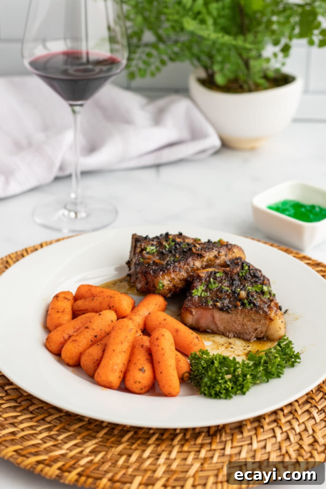 Succulent Herb-Crusted Lamb Chops 3 Plated Lamb Chops and roasted carrots, ready to be served