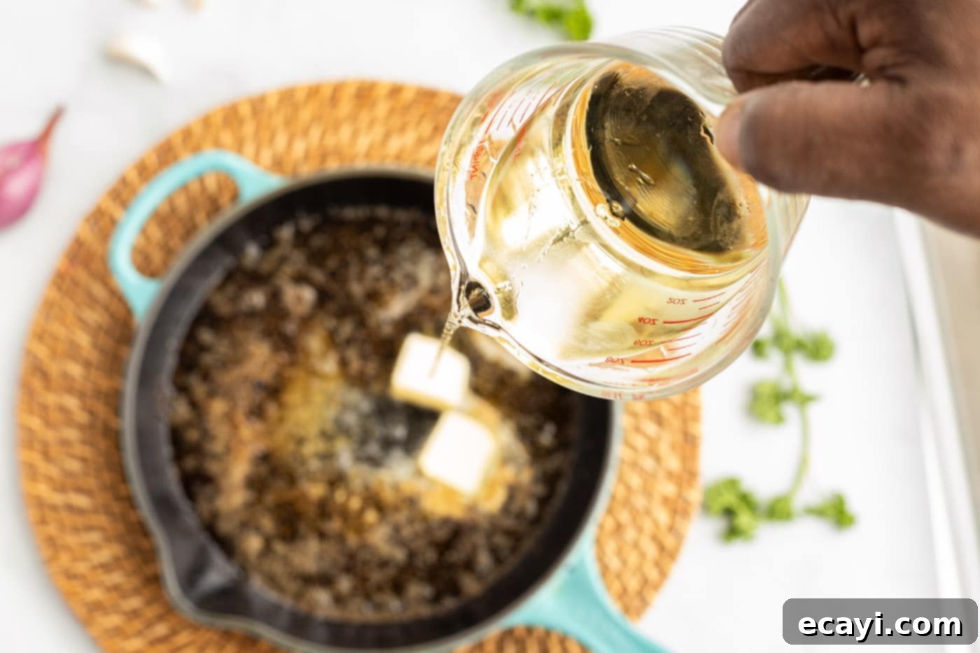 Succulent Herb-Crusted Lamb Chops 9 White wine reduction simmering in a skillet
