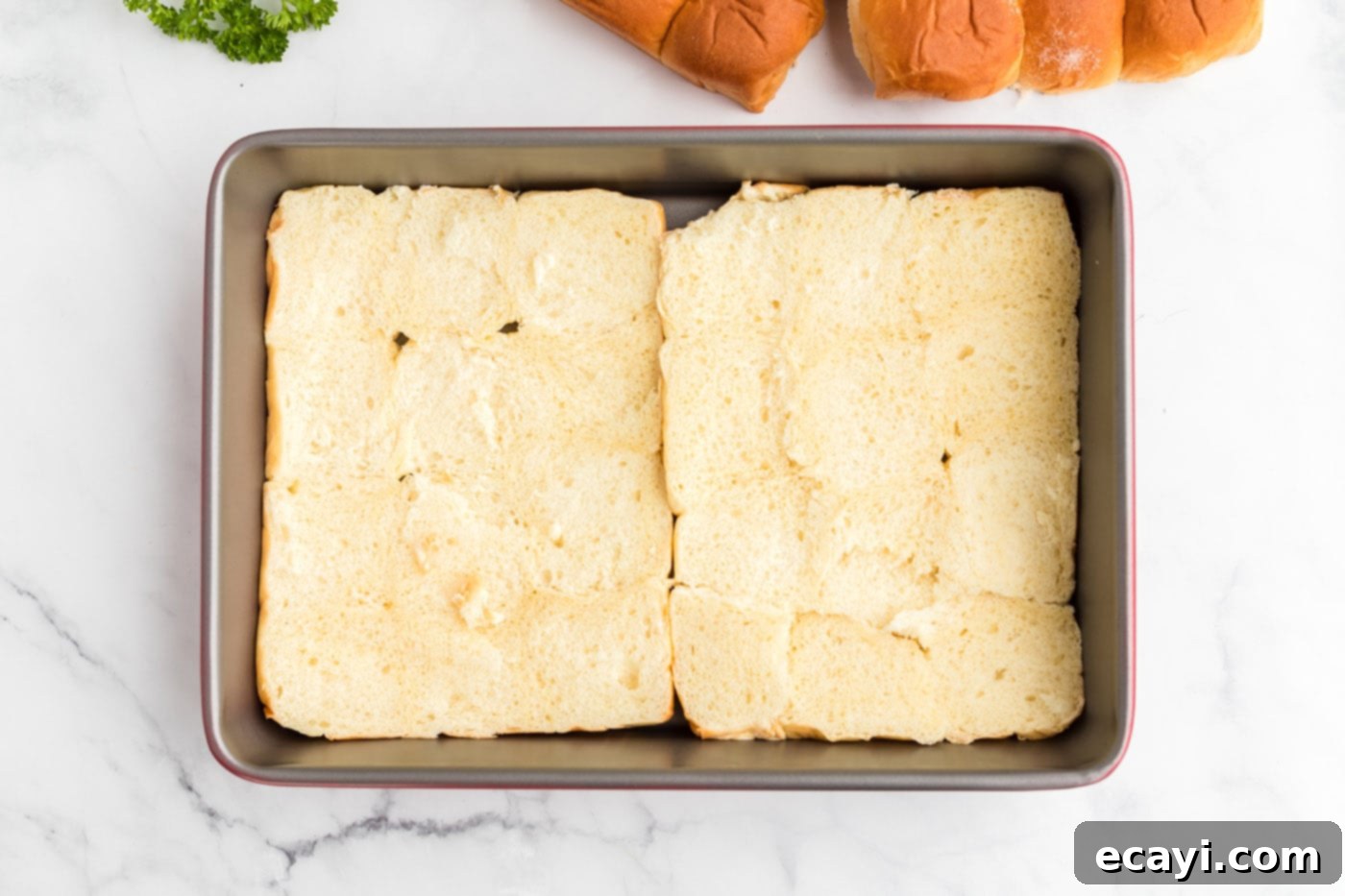 Slow Cooker Mississippi Pot Roast Sliders 6 Bottom layer of Hawaiian rolls perfectly arranged in a 13x9 baking pan.