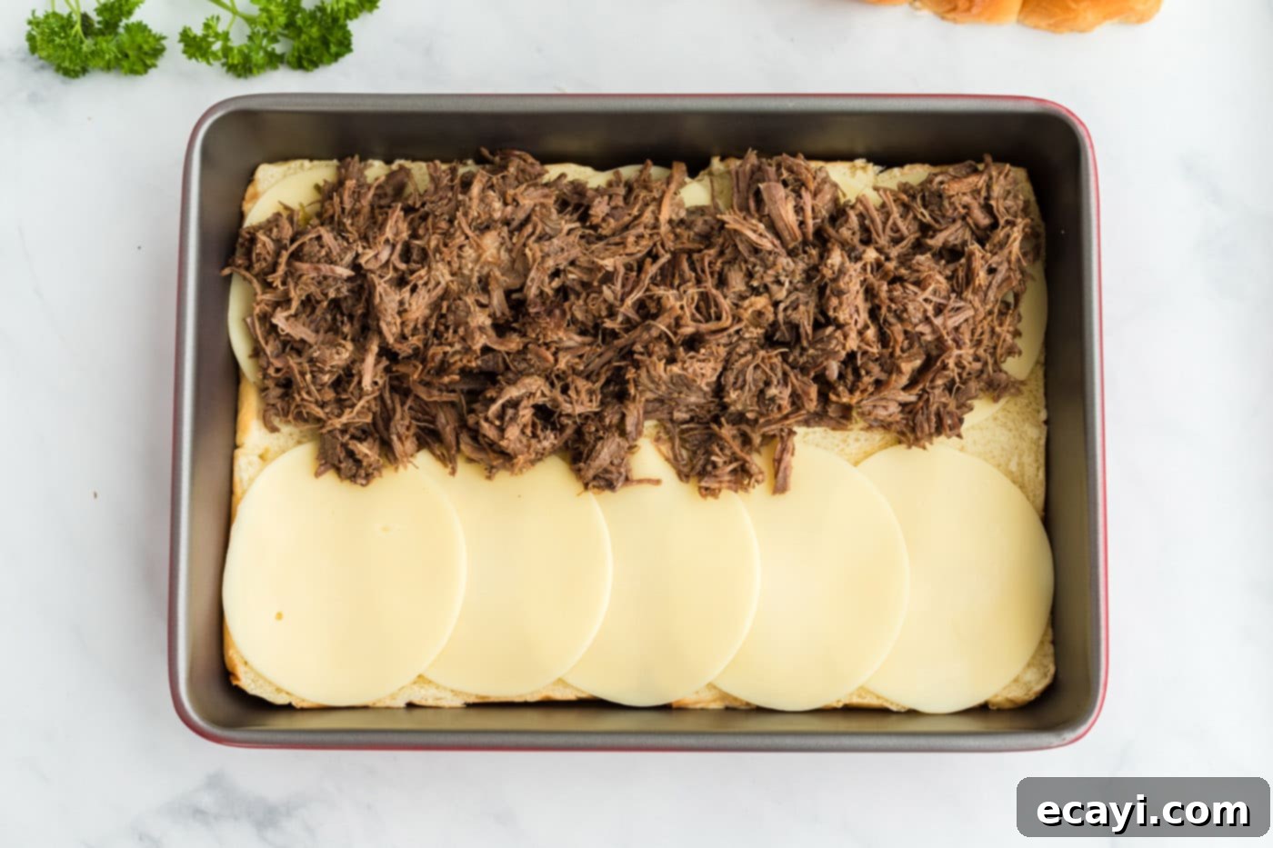 Slow Cooker Mississippi Pot Roast Sliders 8 Shredded pot roast piled generously on top of provolone cheese and Hawaiian rolls.
