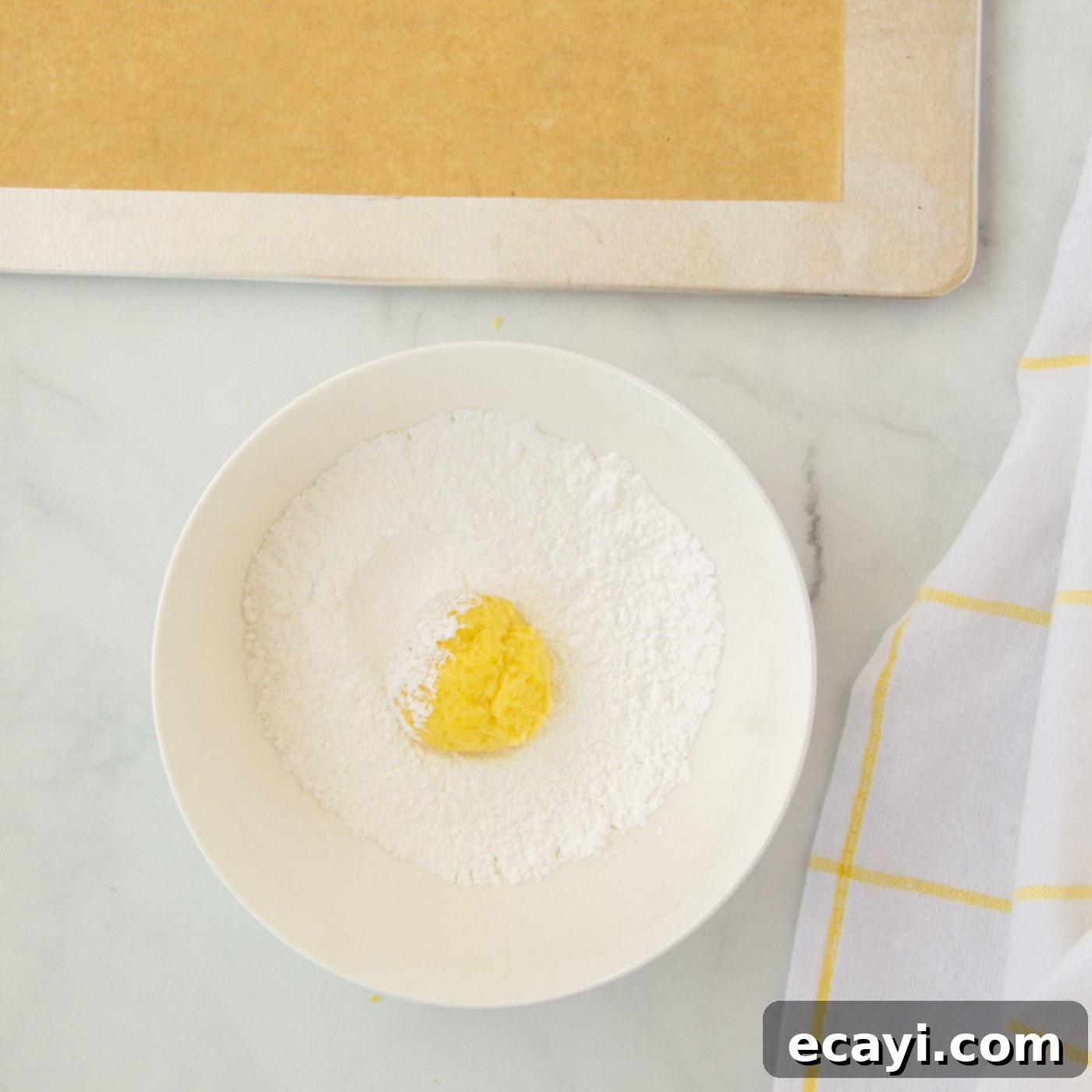 Bright Lemon Cake Mix Cookies 11 Rolling lemon cookie dough balls in powdered sugar