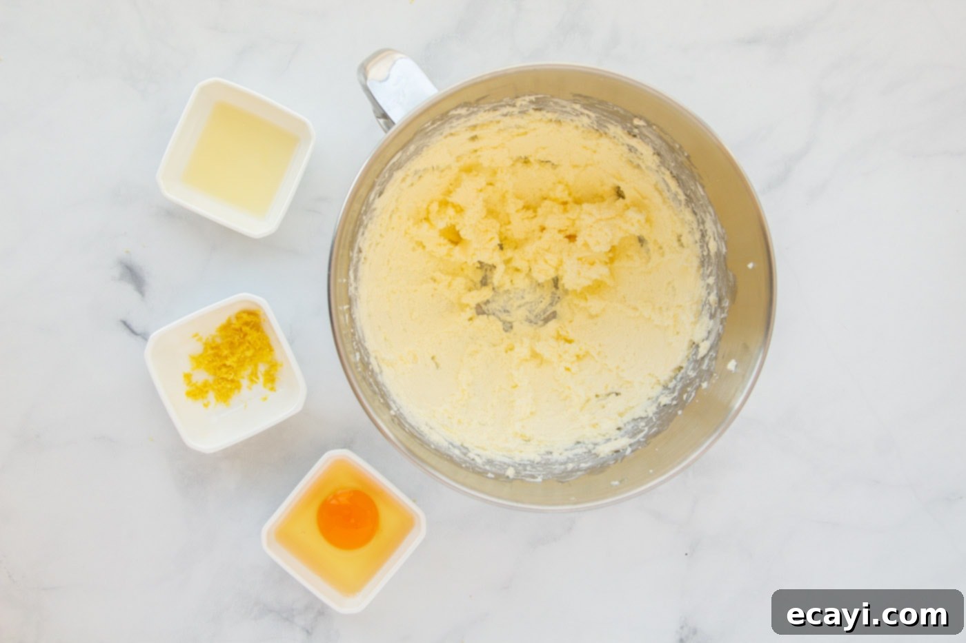 Bright Lemon Cake Mix Cookies 5 Softened butter and cream cheese being beaten in a mixing bowl