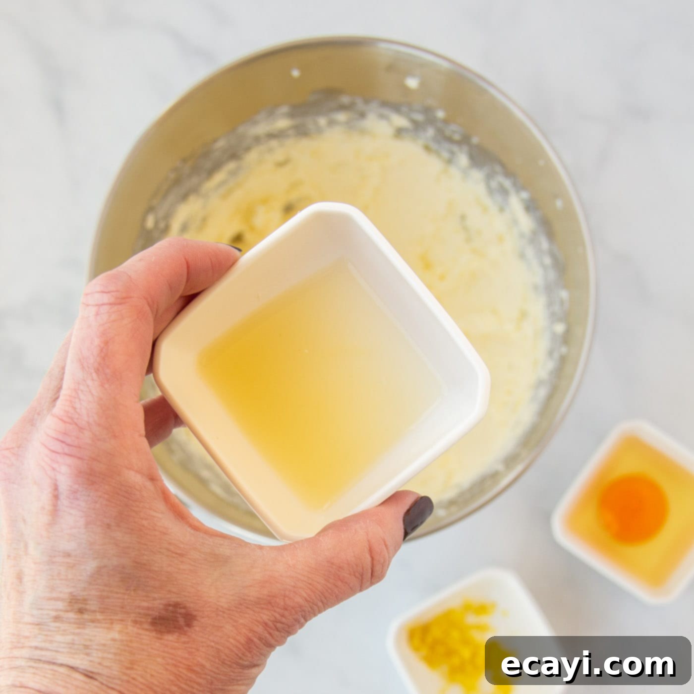 Bright Lemon Cake Mix Cookies 6 Fresh lemon juice being added to the cookie dough mixture