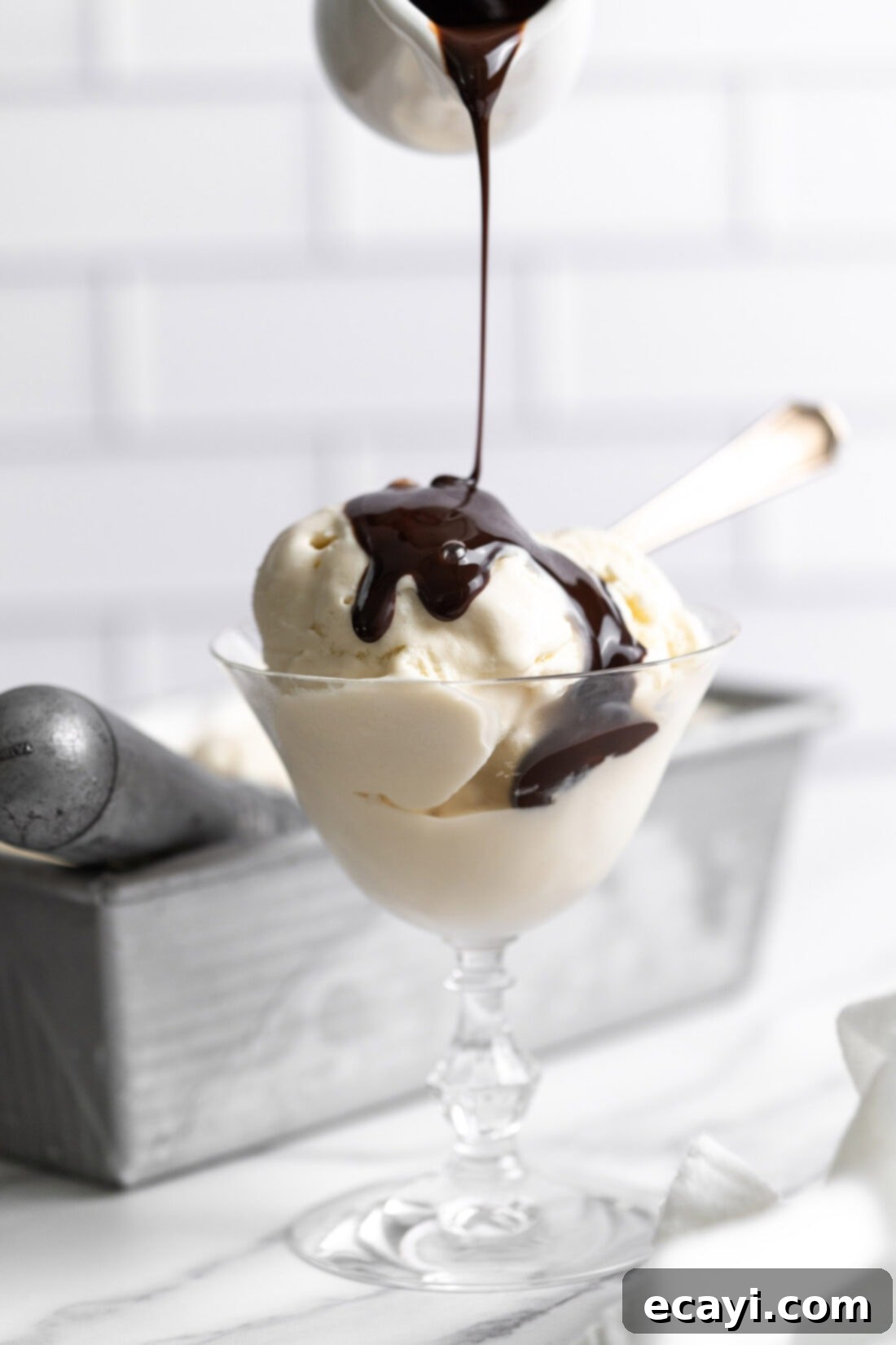 No-Fuss Creamy Ice Cream 3 Homemade vanilla ice cream with chocolate syrup drizzled on top
