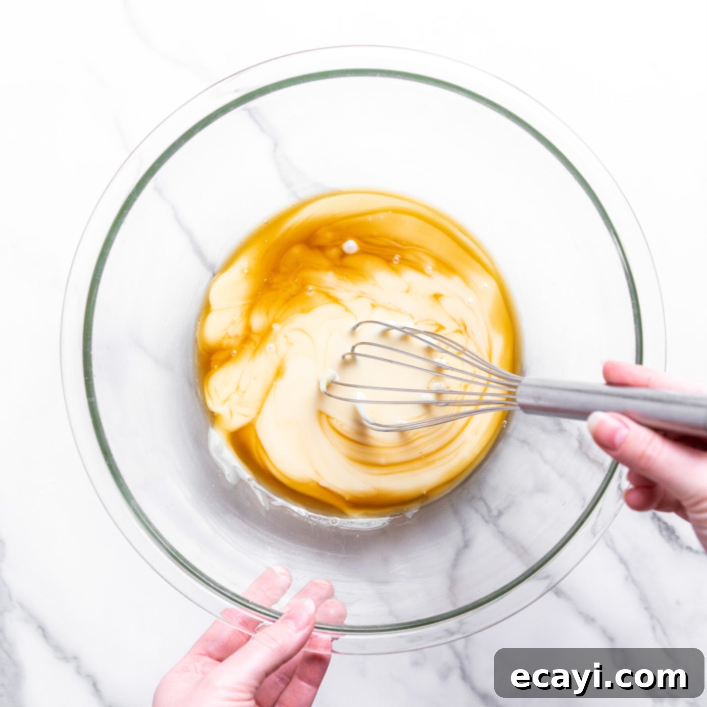 No-Fuss Creamy Ice Cream 5 Whisking sweetened condensed milk with vanilla extract in a large bowl