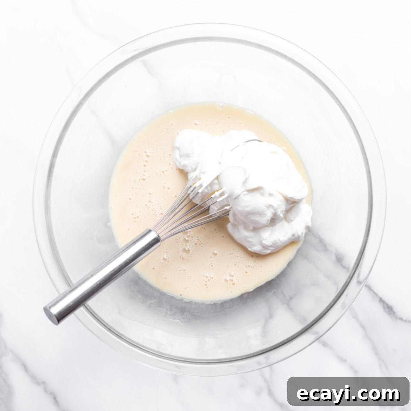 No-Fuss Creamy Ice Cream 7 Whisking a portion of whipped cream into the sweetened condensed milk and vanilla mixture