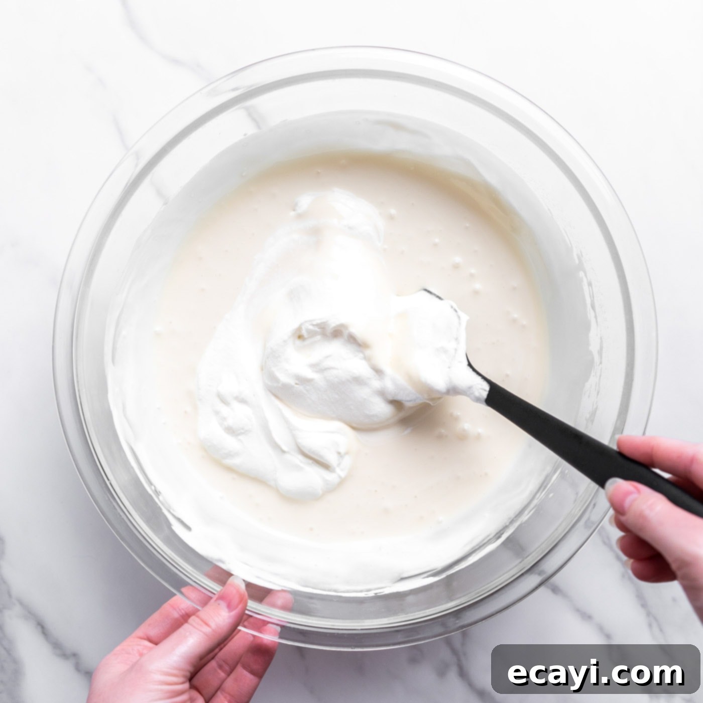 No-Fuss Creamy Ice Cream 9 Folding the remaining whipped cream into the ice cream base with a rubber spatula