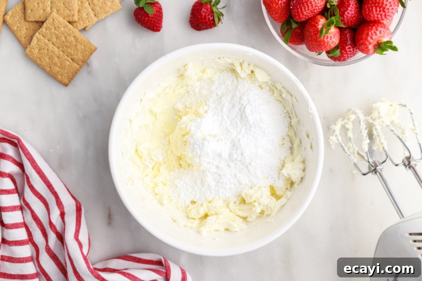 Strawberry Tiered Trifle 8 cream cheese and powdered sugar in a mixing bowl