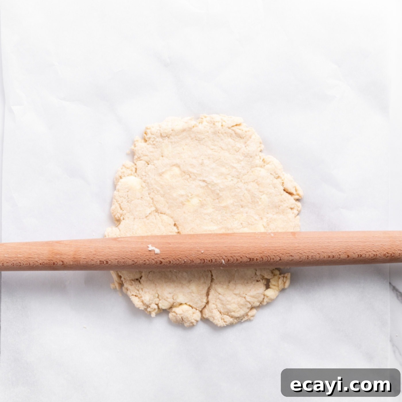 Garden Fresh Strawberry Shortcake 9 Rolling out biscuit dough on a floured surface with a rolling pin