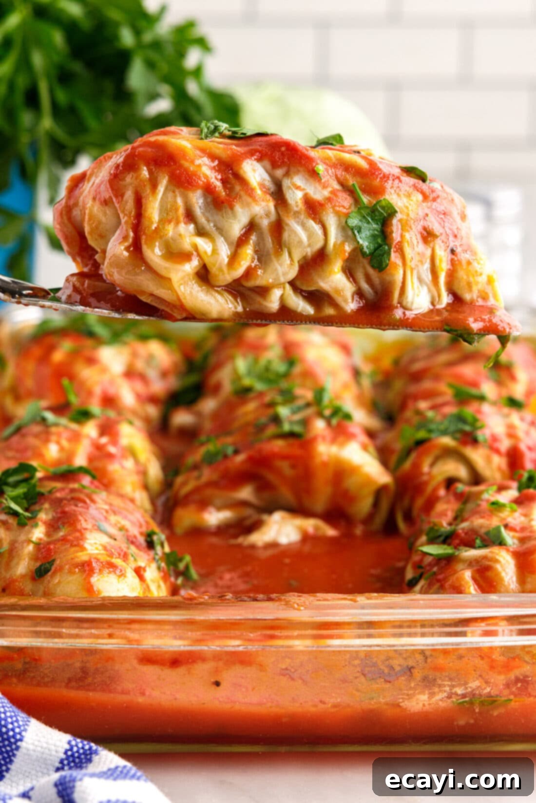 Stuffed Cabbage Delights 3 spatula lifting a Cabbage Roll from pan