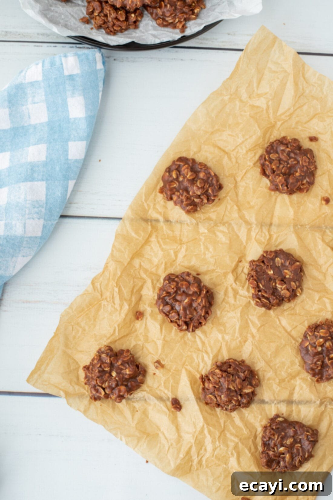 Quick Chocolate No-Bake Delights 12 Close-up of three Chocolate No-Bake Cookies on parchment paper, highlighting their texture