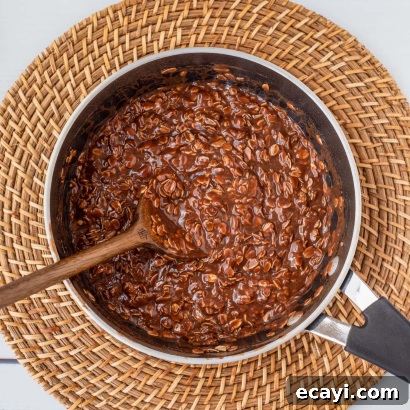 Quick Chocolate No-Bake Delights 10 Wooden spoon mixing the no-bake chocolate cookie mixture in a saucepan