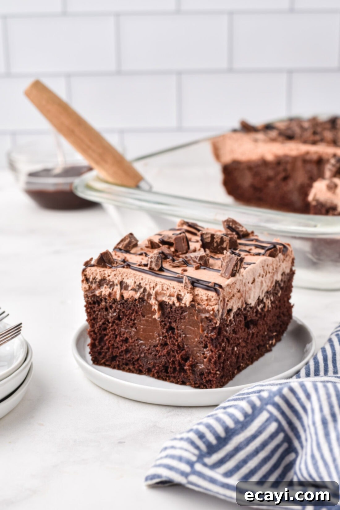 Decadent Chocolate Infusion Cake 2 Decadent slice of triple chocolate poke cake on a white plate