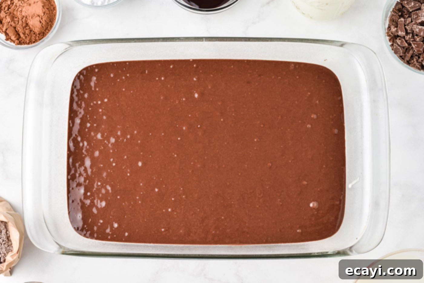 Decadent Chocolate Infusion Cake 5 Devils food cake batter poured into a 13x9 baking dish, ready for the oven