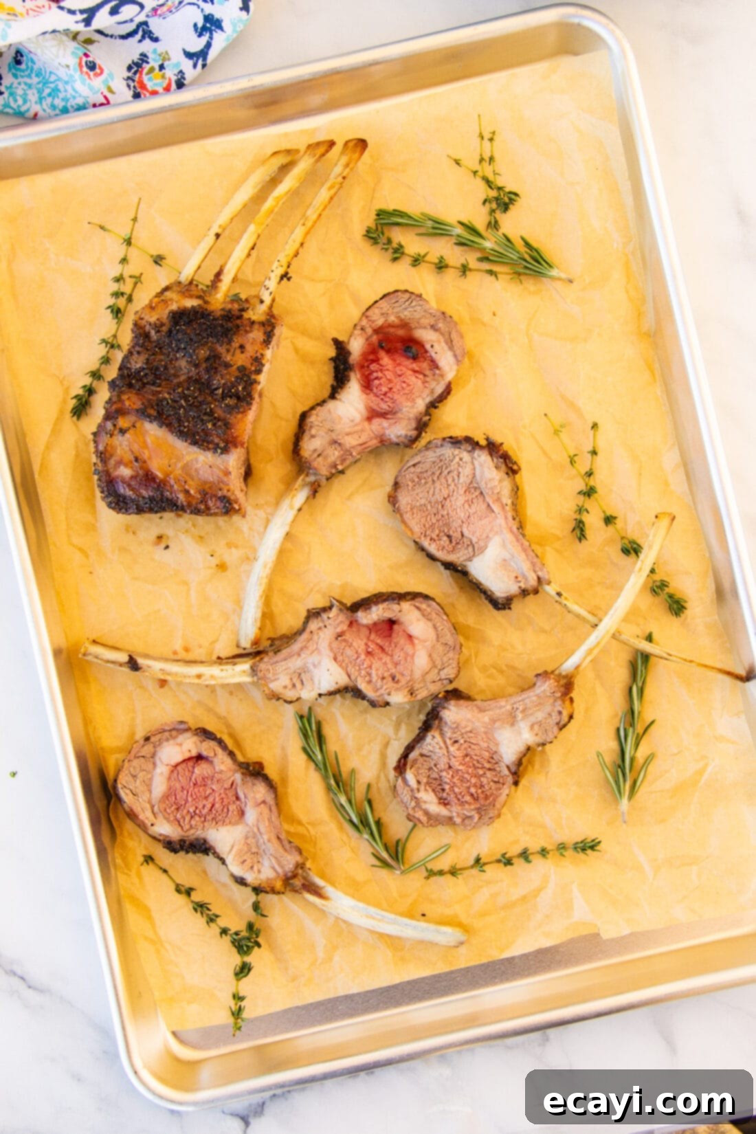 The Butcher's Crown 3 Two racks of lamb chops on a baking sheet, ready for roasting.