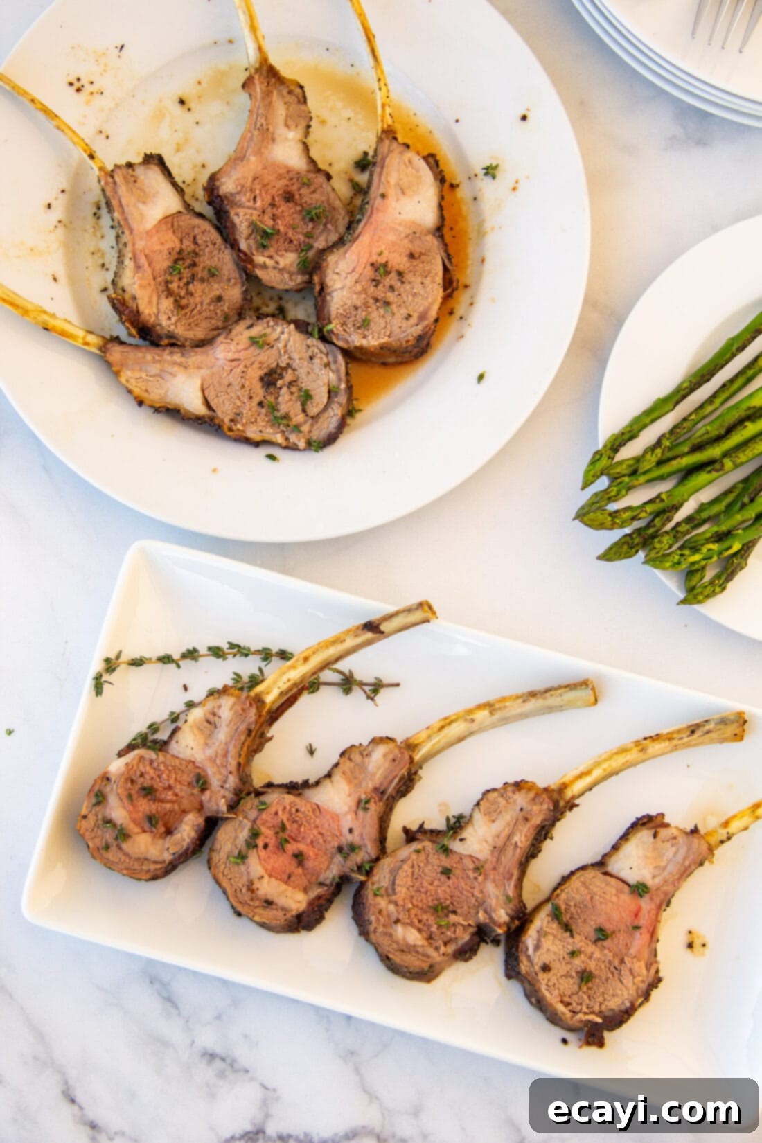 The Butcher's Crown 7 Individual rack of lamb chops served on plates with side dishes.
