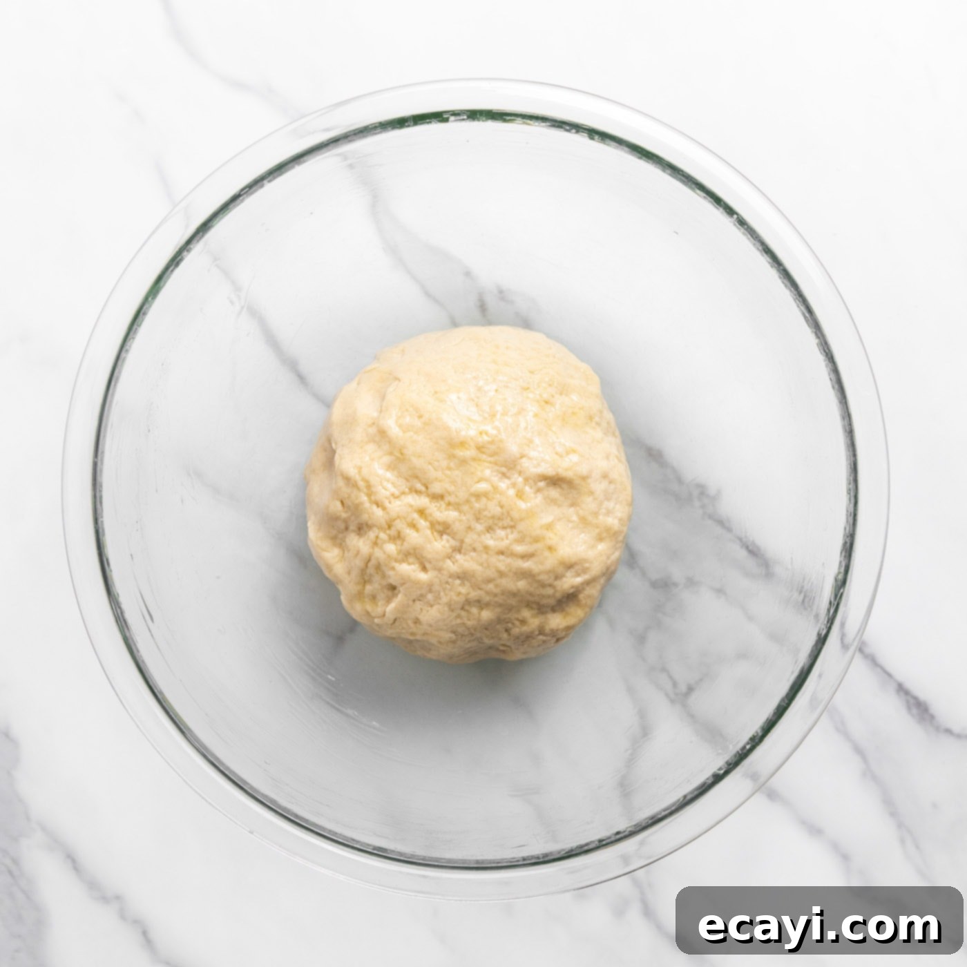 Pillowy Garlic Swirls 8 A perfectly kneaded, smooth dough ball resting in a mixing bowl, lightly oiled and ready for its first rise.