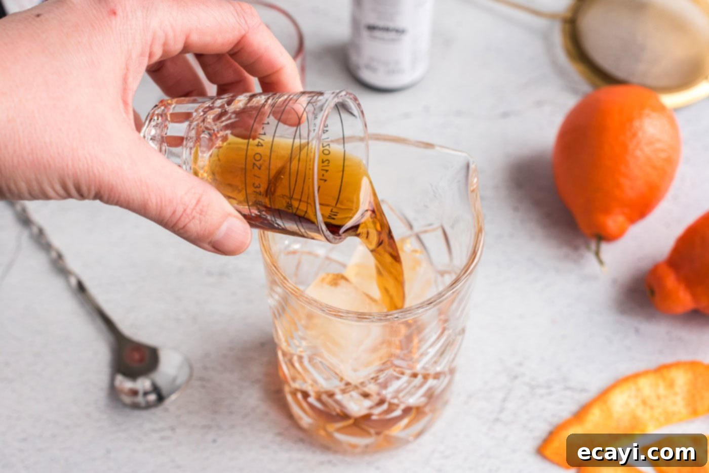 Manhattan's Signature Spirit 5 Pouring rye whiskey and sweet vermouth into a mixing glass filled with ice for a Manhattan cocktail.