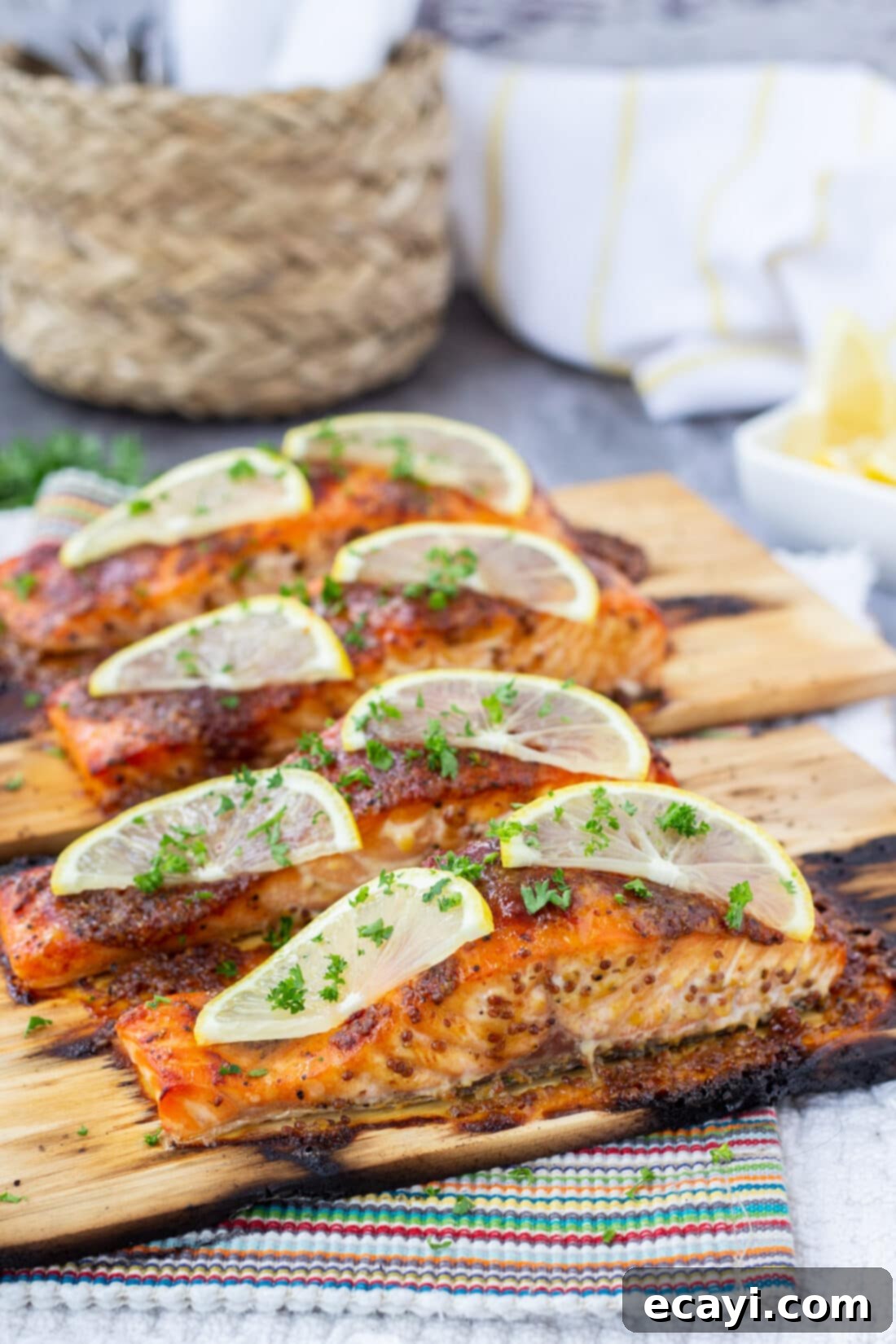 Smoky Cedar Plank Salmon 3 Cedar Plank Salmon garnished with fresh lemon slices and parsley