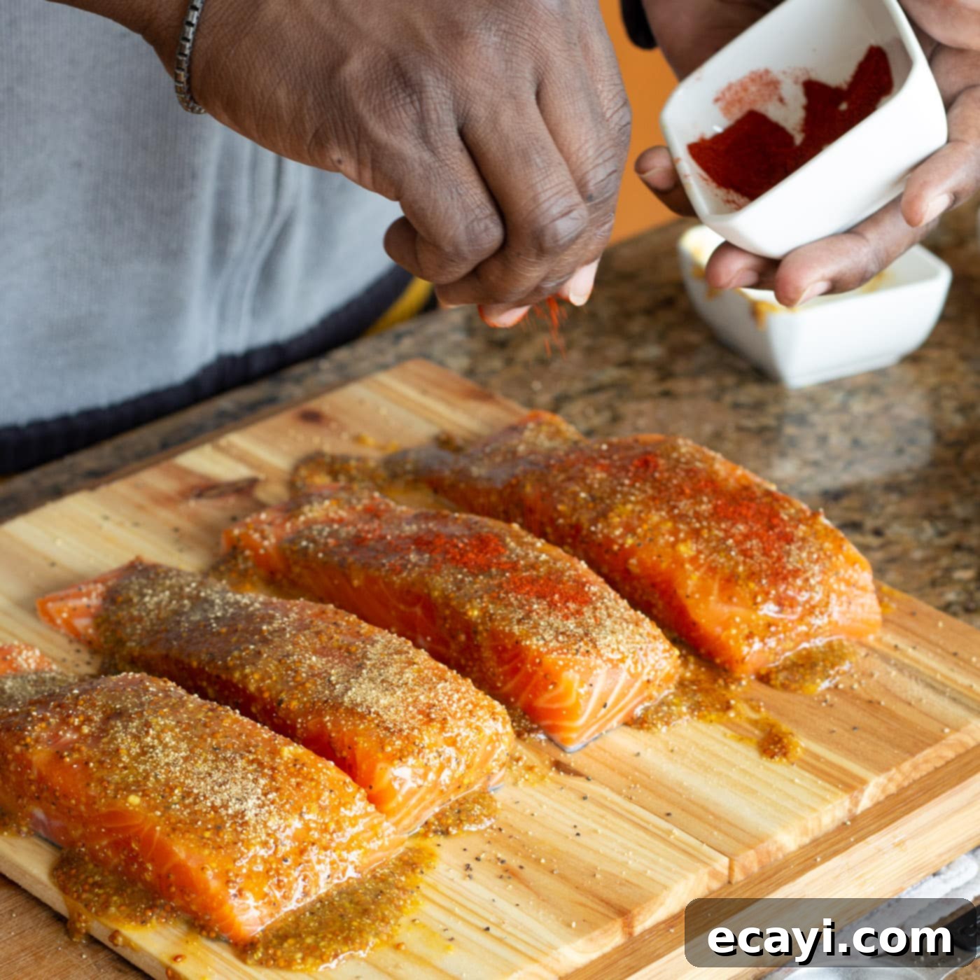 Smoky Cedar Plank Salmon 8 Sprinkling smoked paprika and brown sugar onto the glazed salmon filets