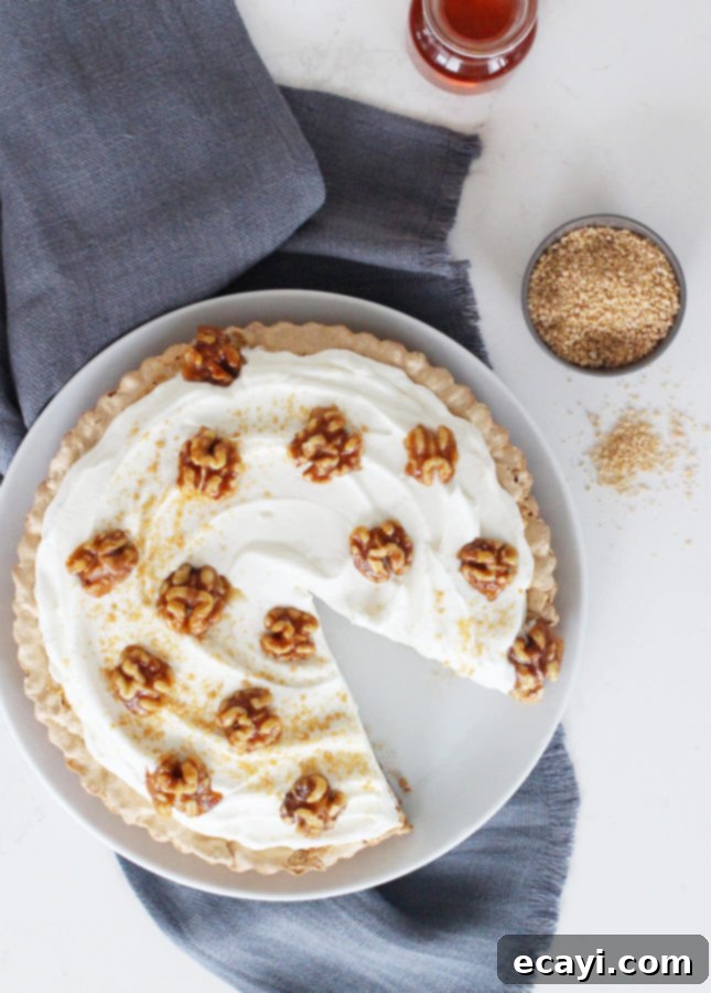 Maple Walnut Cream Tart 5 A slice of Walnut and Maple Cream Tart with a fork, ready to be enjoyed