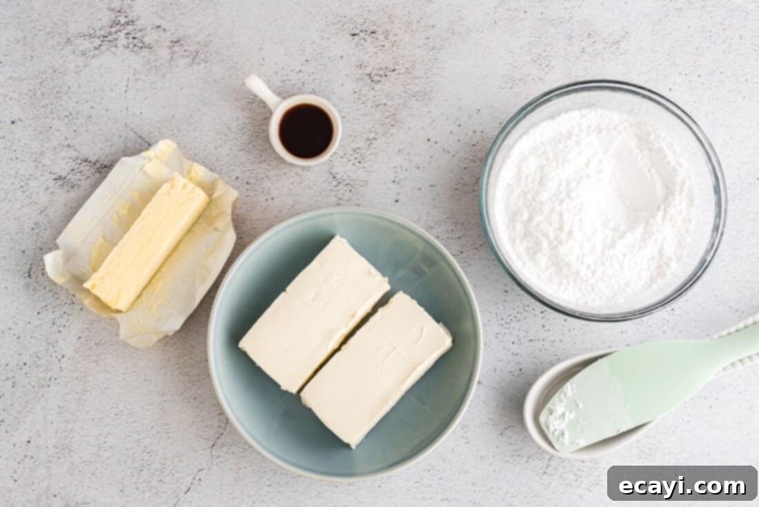 Luscious Cream Cheese Frosting 4 Four essential ingredients for cream cheese frosting laid out: cream cheese, butter, powdered sugar, and vanilla extract.