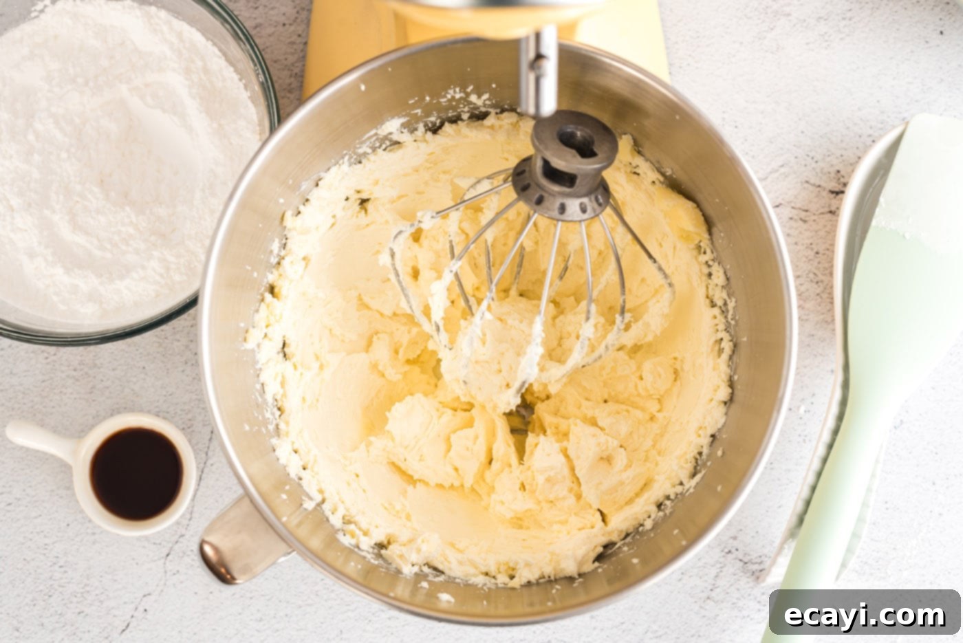 Luscious Cream Cheese Frosting 5 Softened butter and cream cheese being beaten together in a stand mixer until creamy and light.