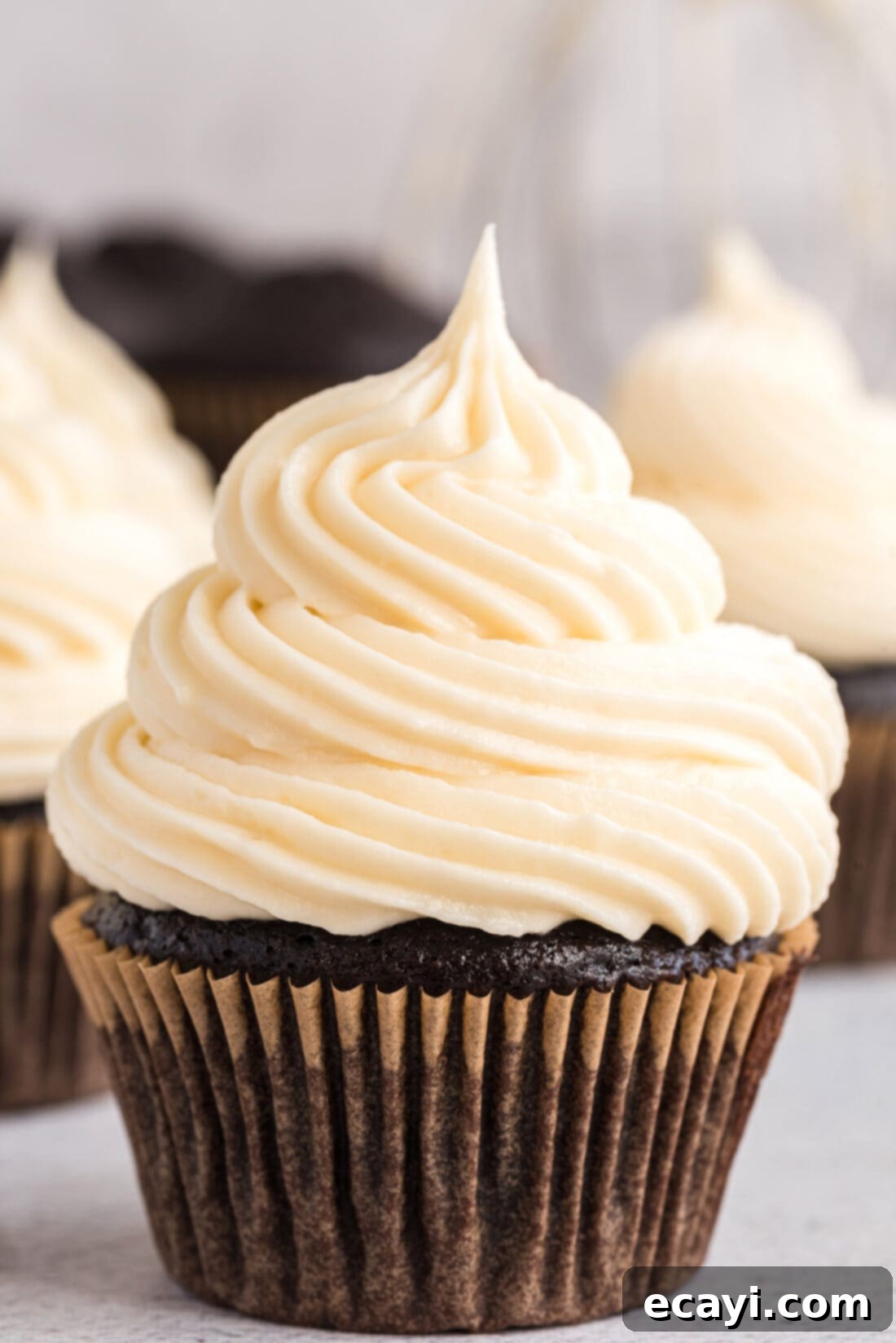 Luscious Cream Cheese Frosting 10 A single cupcake generously frosted with beautiful, fluffy cream cheese frosting, a delightful dessert.