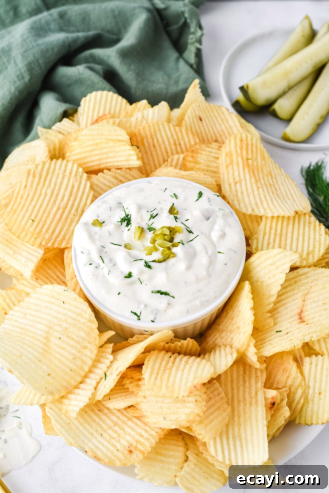 Dill Pickle Delight Dip 3 Close-up of Dill Pickle Dip served with potato chips in a white bowl