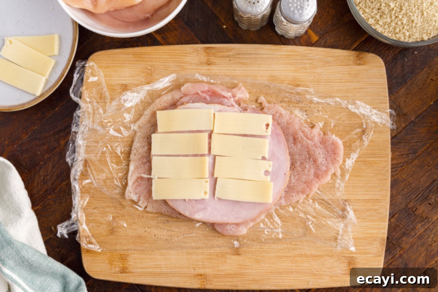 Gourmet Stuffed Chicken Rolls 6 Swiss cheese and ham carefully placed on top of a flattened chicken breast, ready for rolling