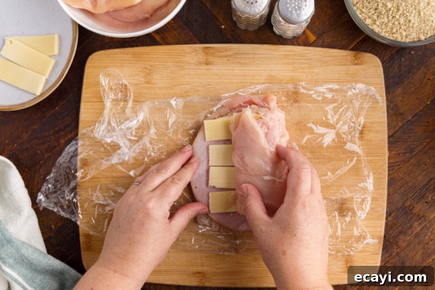 Gourmet Stuffed Chicken Rolls 7 Rolling chicken breast with ham and cheese tightly using plastic wrap for a compact shape